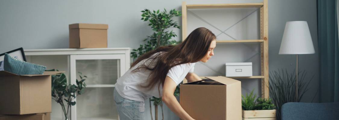 Ohio tenant preparing to move out early, reviewing lease agreement with boxes packed—representing the process of legally breaking a lease in Ohio