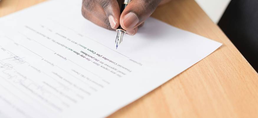 Tenant reviewing and signing a lease renewal agreement in an Ohio apartment, symbolizing the renewal process and negotiation of new terms