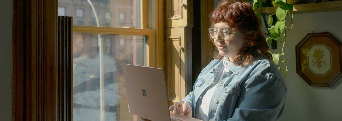 Tenant reading a privacy policy with rental agreement and laptop in an Ohio apartment, representing data privacy for renters online
